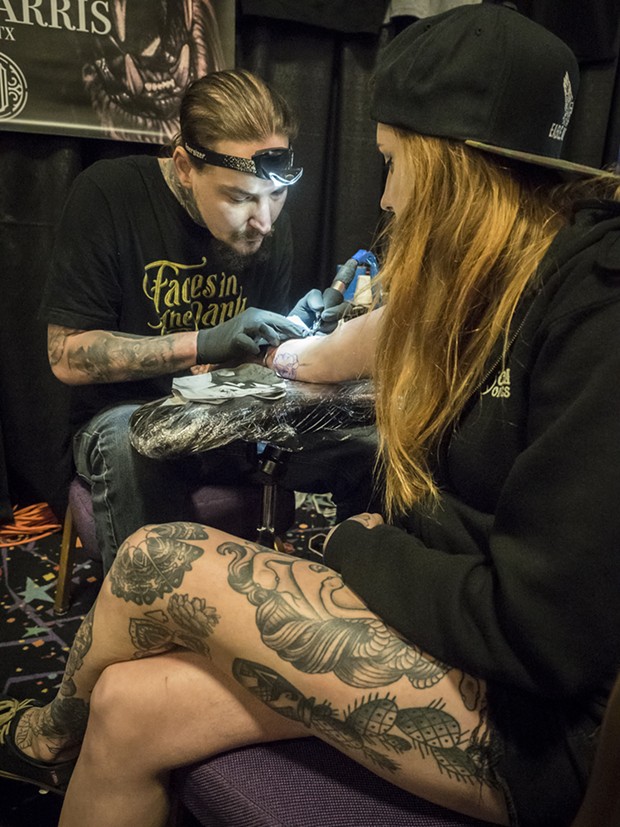Tattoo artist Megan Franklin, of Springfield, Missouri, had Tye Harris, of Kyle, Texas, add a realistic tattoo of her grandparents on their wedding day to her arm at the Inked Hearts Tattoo Expo at Blue Lake Casino and Hotel this past weekend. - PHOTO BY MARK LARSON