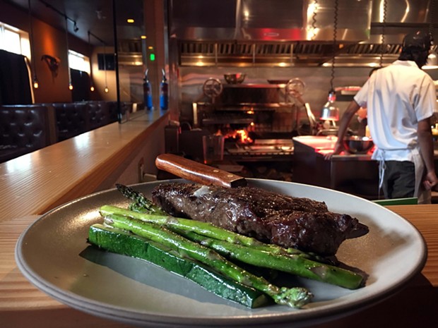 The New York strip steak, grilled vegetables and a counter view of the fire. - JENNIFER FUMIKO CAHILL