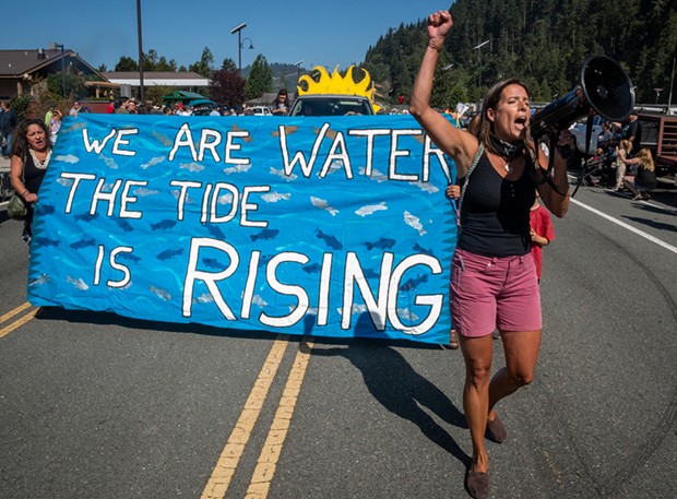 This participant in the 2019 Klamath Salmon Festival parade led chants in support of tribal water rights, dam removal and environmental protection.