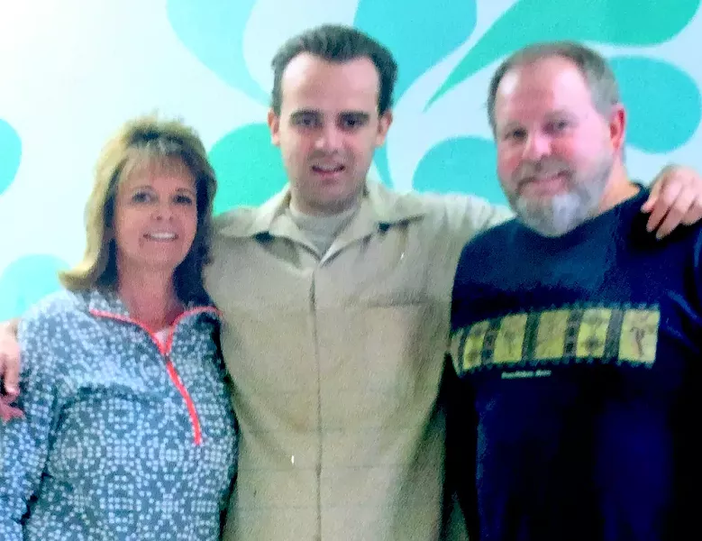 Jeffrey Jurgens at Atascadero State Hospital a couple of years ago, surrounded by his parents. - FAMILY PHOTO VIA JOANNA JURGENS