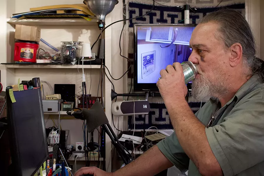 Self-described "digital nomad" Robert Stretton works on his pirate radio station in the last place he resided, a fifth floor office building in Eureka from which he was ultimately evicted. - PHOTO BY T.WILLIAM WALLIN