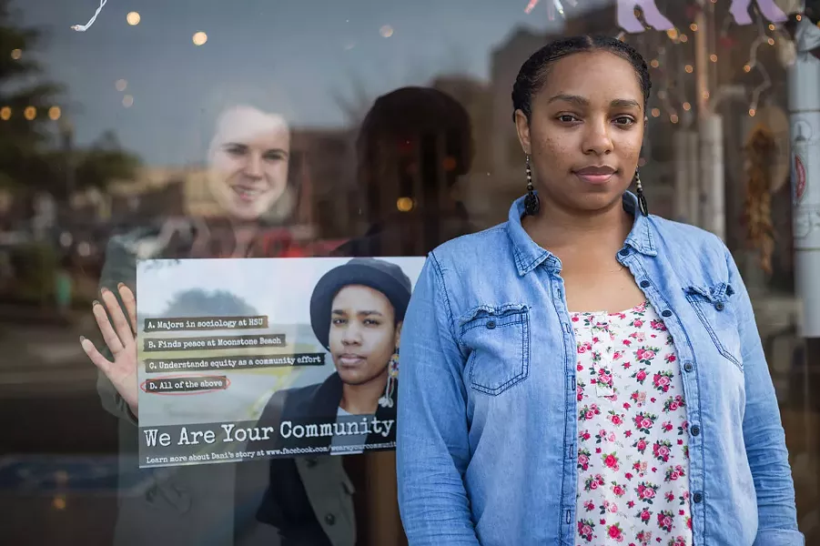 Erin Youngblood-Smith (right) stands in front of PastaLuego in Arcata as Amy Mathieson (left) hangs a We Are Your Community poster in the window. - PHOTO BY SAM ARMANINO