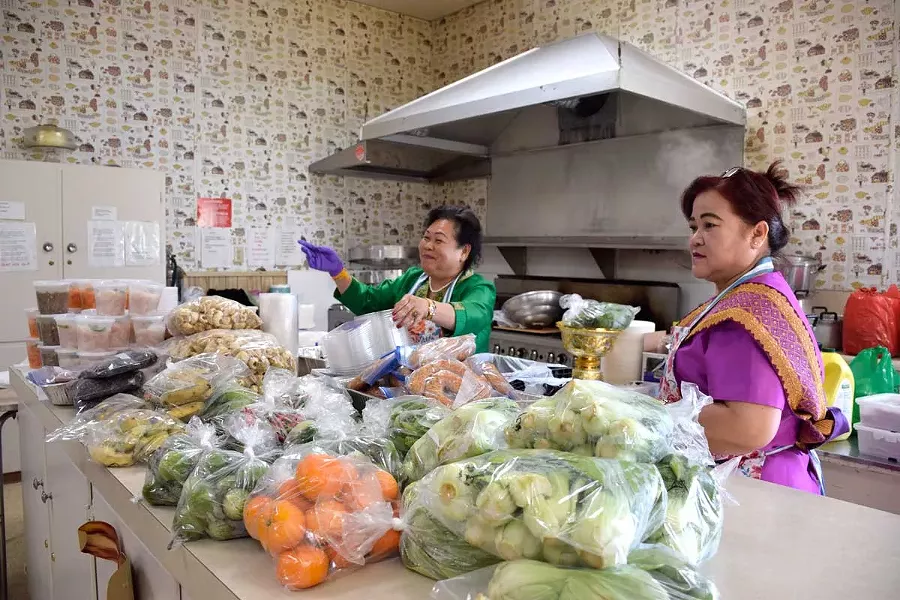 Joy Vonphachant and Penny Senamaatry cook up a storm in the Humboldt Grange kitchen. - PHOTOS BY JENNIFER FUMIKO CAHILL