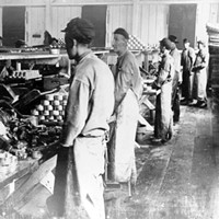 Chinese workers fill cans at a cannery in Astoria, Oregon.