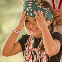 Dakotarose Scott, 5, of Klamath, adjusts her crown.