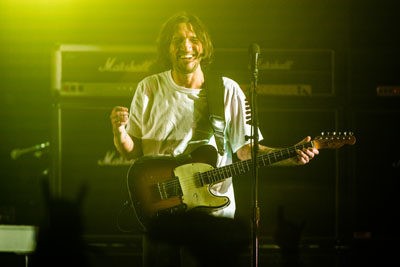 Guitarist, John Frusciante, who has newly rejoined the band after his absence since 2006’s Stadium Arcadium Album and Tour, smiles at the crowd in between songs. - PHOTO BY CHRIS TUITE FOR THE TWO RIVERS TRIBUNE