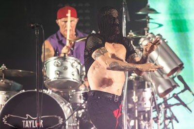 Anthony Kiedis pulls his shirt over his head while dancing onstage during his vocal break. - PHOTO BY CHRIS TUITE FOR THE TWO RIVERS TRIBUNE