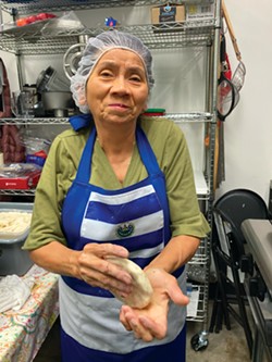 PHOTO BY JENNIFER FUMIKO CAHILL - Jorgelina Granados hand forms a pupusa at her Pupuseria San Miguel.