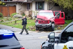 PHOTO BY MARK MCKENNA - The suspects' truck where it came to land in a private yard after crashing into another vehicle at Dolbeer and Harris streets in Eureka on April 18.