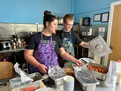 PHOTO BY JENNIFER FUMIKO CAHILL - Louisa Hunsucker and Ian Rowley serve free lunches at the Jefferson Community Center's J Caf&eacute;.