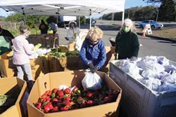 SUBMITTED - Food for People volunteers set up for a recent drive-thru food distribution event.