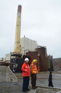PHOTO BY GRANT SCOTT-GOFORTH - Coast Guard and EPA representatives stand in front of the Samoa Pulp Mill smokestack, which is slated for military demolition soon.