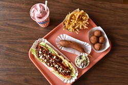 DREW HYLAND - The deluxe grilled chili dog, corn dog, fries, hush puppies and a strawberry shake at Bob’s Footlongs. Styling by Lynn Leishman.