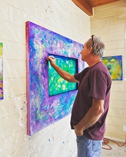 THE ARTIST AT WORK Los Osos artist Tom Sage puts the finishing touches on one of his colorful abstract works. - PHOTO COURTESY OF TOM SAGE ART