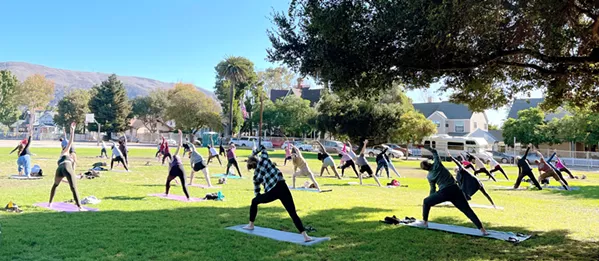 GRATITUDE Each Sunday, SLO Yoga Center hosts an outdoor yoga class in the park. Its Thanksgiving weekend class (pictured) drew a big turnout in Emerson Park. - PHOTO COURTESY OF STEPHANIE STACKHOUSE