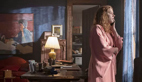 HITCHCOCK HOMAGE Agoraphobic child psychologist Dr. Anna Fox (Amy Adams) begins spying on her neighbors in this take on Alfred Hitchcock's Rear Window, streaming on Netflix. - PHOTO COURTESY OF NETFLIX