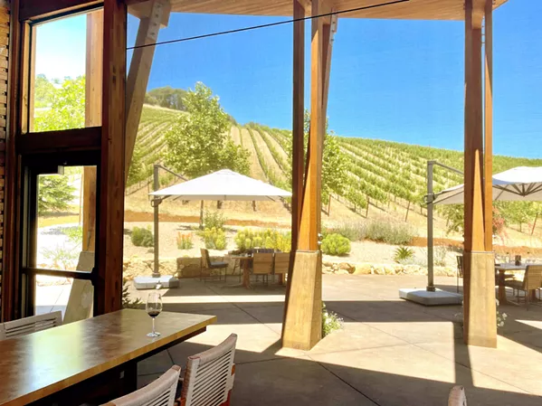 OUTSIDE IN Sixmilebridge's new-age patio screens are nearly invisible, but only 3 percent porous. The screens enable the tasting room to host guests "outdoors" with climate control during Paso's extreme temperature swings. - PHOTO BY CHERISH WHYTE