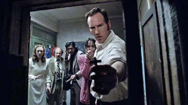 THE POWER OF CHRIST COMPELS YOU Ed Warren (Patrick Wilson) uses his trusty cross to clear the way, in the middling horror threequel The Conjuring: The Devil Made Me Do It. - PHOTO COURTESY OF NEW LINE CINEMA