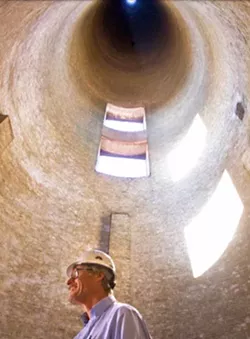 INSIDE THE STACKS Morro Bay is considering whether to demolish the iconic stacks that line the bayfront. Here, a prior plant manager stands inside the first stack that was constructed in the 1950s. - PHOTO COURTESY OF FACTS ABOUT THE STACKS FORUM POWERPOINT