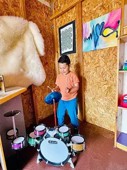 MAKING MUSIC A young Exploration Discovery Center patron makes some tunes in the Music Shed. - PHOTO COURTESY OF EXPLORATION DISCOVERY CENTER