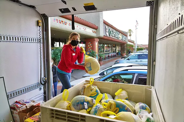 TURKEY DAY Turkeys get unloaded from a food bank truck ahead of Thanksgiving. The organization and its partner agencies distributed hundreds of free birds this year. - PHOTO COURTESY OF SLO FOOD BANK