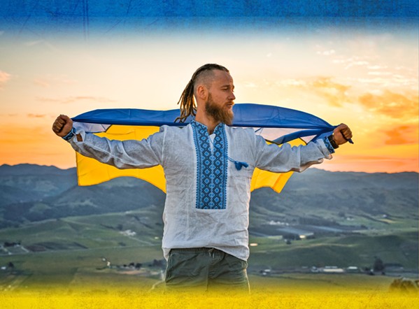 PROUD UKRAINIAN Ukrainian and San Luis Obispo resident Slava Narozhnyi poses on Bishop Peak with his country's flag. Narozhnyi is raising money to help his family and others in the city of Kharkiv, one of the hardest hit in Russia's invasion. - COVER PHOTO COURTESY OF SLAVA NAROZHNYI
