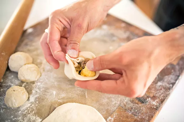 HAND CRAFTED Co-owner Mike Whittaker hand-folds each and every bao. This one is filled with chorizo, ground beef, breakfast sausage, soft scrambled egg, onion, and garlic, and it's served with a maple chili dipping syrup. - PHOTO COURTESY OF SHANNON MCMILLEN