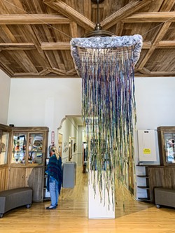 SPRING RAIN Cambria-based artist Carolyn Chambers took on this 8-foot-long installation piece hanging at the Cambria Center for the Arts thanks to inspiration from Lenore Tawney and Olga de Amaral, who transformed textile and fiber art in the mid-20th century. - PHOTO BY CAMILLIA LANHAM