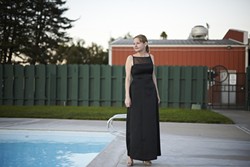 CLASSY :  Margaret Shepard Rousset shows off her dress around the Elks Lodge pool. - PHOTO BY STEVE E. MILLER