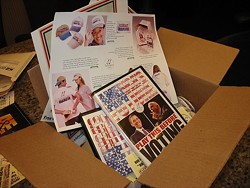 A BOX OF OBAMA :  On TwoVoters.com, people can buy a box of campaign materials featuring buttons, tickets, and posters. - PHOTO BY PATRICK HOWE