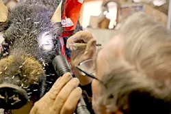 DETAILS: Don uses a flashlight to make sure the eyes are set just how he wants them. One of the most technical parts of taxidermy is getting the eyes to look realistic by making little adjustments. - PHOTO BY DYLAN HONEA-BAUMANN