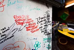 WRITING ON THE WALL: Fans from across the country, both young and old, have taken to Jeffrey’s unique act, writing their well wishes on the wall of his truck. - PHOTO BY KAORI FUNAHASHI