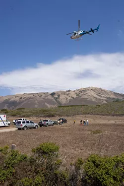 HIGH FLYING WEED: A California Highway Patrol helicopter dropped off bundles of marijuana found at a remote beach near Piedras Blancas for Sheriff’s Department trucks to haul them off to the sheriff’s headquarters. - STEVE E. MILLER