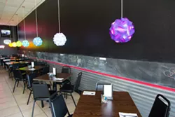 A GREAT PLACE TO PARK: The new restaurant, complete with truck tire installed in bar and joyful colored lights, reflect Nunes’ energetic personality and vibrant Asian fusion creations. - PHOTO BY TOM FALCONER