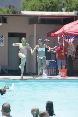 ONE, TWO, THREE! : Two young girls leapt in tandem into the SLO Elks Lodge pool. - PHOTOS BY GLEN STARKEY