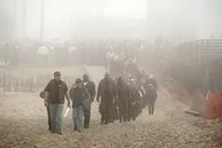 OUT OF THE MIST : Hundreds of dangerous badasses managed to walk in single file and behave themselves. Good bikers! - PHOTO BY STEVE E. MILLER