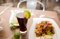EXOTIC ELIXER: Nothing pairs better with Mistura’s modern Peruvian fare than a tall, cold glass of hand-crafted chicha morada, made with purple corn, fruit, cloves, and cinnamon. - PHOTO BY KAORI FUNAHASHI
