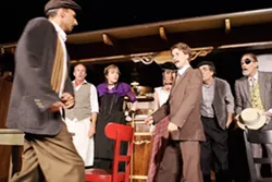 DUEL OF THE PENS : Freddy (Joe Eister), Germaine (Gailee Walker), Suzanne (Lauren Moore), Gaston (Dwaine Edwards), and Sagot (Michael Siebrass) watch as Picasso (Guy Marziello) and Einstein (Justin Thieleman) struggle to determine whose genius is greater. - PHOTO BY STEVE E. MILLER