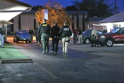 RUDE AWAKENING : Officers served warrants at a Paso Robles motel and several other locations at about 5:30 a.m. on Dec. 12, 2012, resulting in the arrest of 15 suspected conspirators in drug trafficking. Court records now show that the suspects weren’t as closely connected as law enforcement first implied. - FILE PHOTO BY STEVE E. MILLER