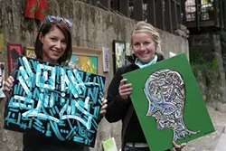ORIGINALS : Becky Griswold and Maggie Nichols clutch their first pieces of original art. - PHOTO BY GLEN STARKEY