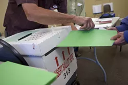 VOTING MYSTERY : Ballots poured in on election night (pictured), but not everyone’s voice was heard this season. An elusive individual linked to a conservative group may be to blame for roughly 900 voter cards turned in late to the SLO County Clerk’s Office. - PHOTO BY STEVE E. MILLER
