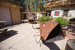 HARMONY DINING : A new restaurant featuring Italian-Swiss eats is slated to open next spring in the old dairy community of Harmony. Pictured, repurposed metal will be used to create interesting and inviting fireplaces for a rustic outdoor patio. - PHOTO BY KAORI FUNAHASHI