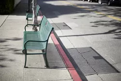BENCHES? WE DON’T NEED NO STINKING BENCHES: According to SOFCO, removing these green park benches will help eliminate panhandling downtown. - PHOTO BY GLEN STARKEY