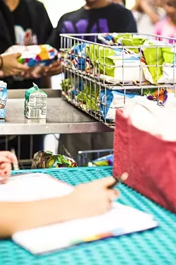 FREE LUNCH: Kids receive free lunches this summer from the Lovin’ Lunchbox program, hosted by the Food Bank Coalition. - PHOTO BY HENRY BRUINGTON