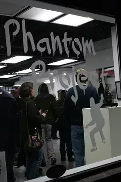FOLLOW THE SIGN: The Phantom Project’s iconic sign is currently up at 672 Higuera St., where the show hangs through March 2. Look for the sign on other empty retail spaces as more of these ephemeral shows pop up around the county. - PHOTOS BY GLEN STARKEY