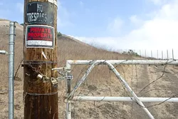 THIS LAND IS MY LAND: Landowner Rob McCarthy has fenced off this entrance to the Ontario Ridge trail off Cave Landing Road near Avila Beach, aggravating many hikers and sparking a multi-party land-use skirmish. - PHOTO BY STEVE E. MILLER