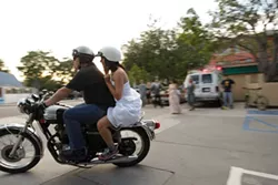 RUNAWAY WEDDING PARTY : The runaway wedding party flash mob concluded when our bride hopped on a motorcycle driven by New Times’ Glen Starkey. - PHOTO BY STEVE E. MILLER