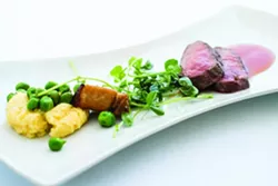 DELICIOUS : Apple Farm Chef Steven Smeets creates lamb loin with polenta, pork belly, peas, and tomato gastrique.