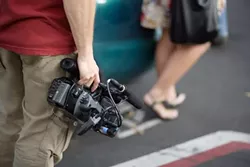 T-SHIRT FLASH MOB : Matthew Zolynsky served as cameraman during the colored shirt flash mob. - PHOTO BY STEVE E. MILLER