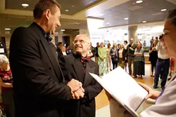THE LOOK: David Robinson (right) beams up at his now-spouse Gerald Lindemulder, as Rev. Helen Carroll of SLO’s Unitarian Universalist Fellowship performs their wedding ceremony. - PHOTO BY STEVE E. MILLER